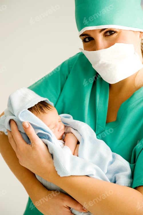 Preview: A Medical Practitioner Holding A Newborn Baby