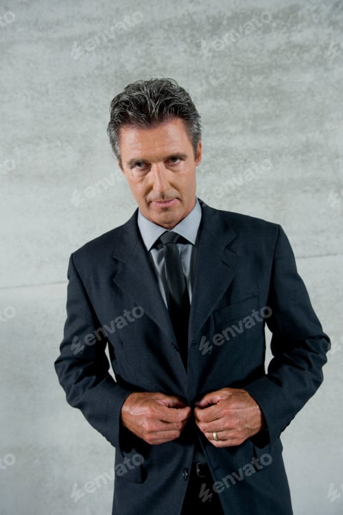 Preview: A Mature Businessman Buttoning His Jacket