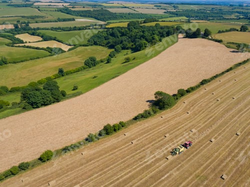 Preview: Aerial View Of Tractor Baling Hay In Field