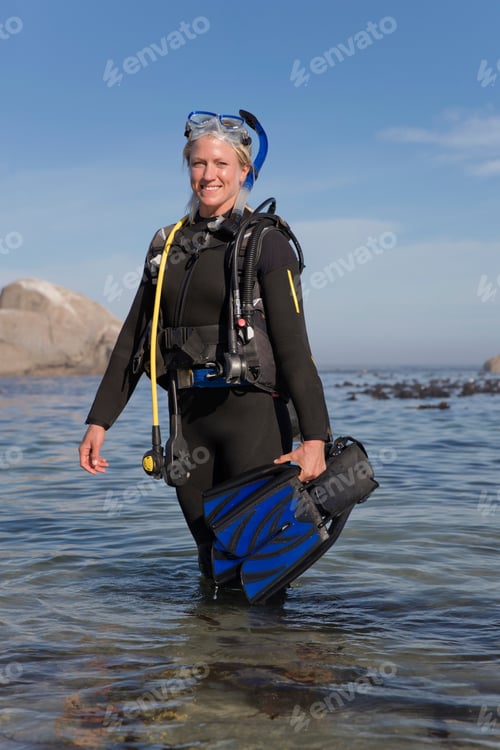 Preview: Woman In Wetsuit Going Ocean Scuba Diving From Beach And Smiling At Camera