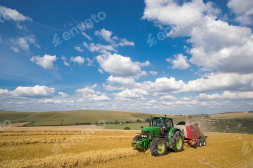 Preview: A Tractor Stacking Straw Using A Baling Machine In A Rural Field.