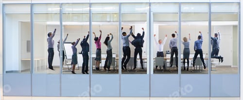 Preview: Wide Shot Through An Office Window With A Group Of People Jumping In The Air.