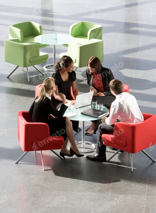 Preview: A Group Of Four Business Colleagues Holding An Informal Meeting