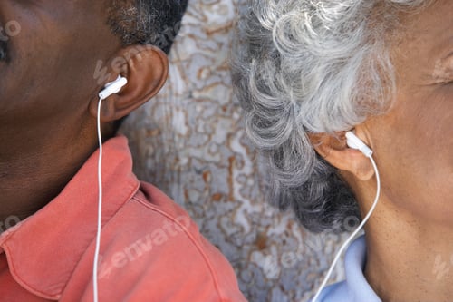 Preview: Close-Up Shot Of A Shared Earphone Between A Senior Couple Listening To Music.