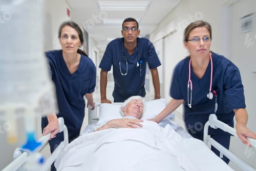 Preview: Wide Shot Of The Emergency Medical Team Wheeling The Patient Along The Hospital Corridor