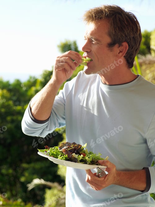 Preview: Potrait Of A Man Eating Lettuce Salad From A Plate.