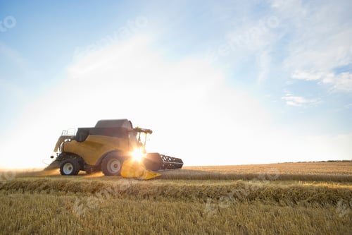 Preview: Wide Shot Of A Combine Harvester Running Across A Rural Field On A Sunny Day.