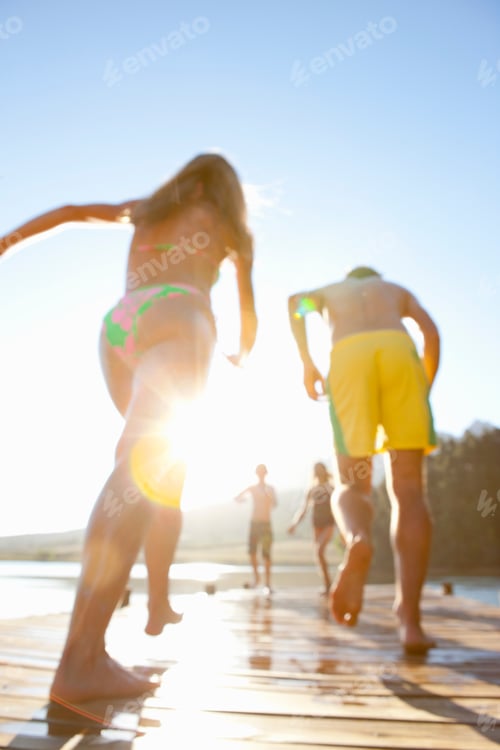 Preview: Blurred Image Of A Family Running On A Wooden Dock At A Lake