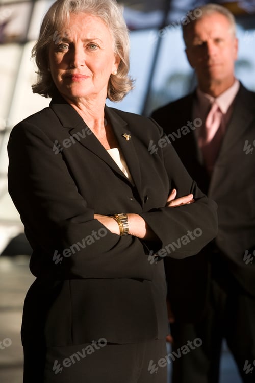 Preview: Portrait Of Senior Businessman And Businesswoman In Airport Building