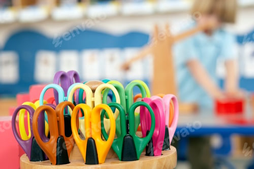 Preview: Close Up Shot Of A Bunch Of Scissors With A Boy In The Background.