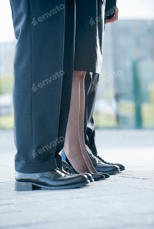 Preview: Two Businessmen And A Businesswoman Standing In A Row, Close-Up Of Their Legs