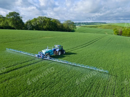 Preview: Aerial View Of Tractor Spraying Crop In Green Farm Fields With Pesticide