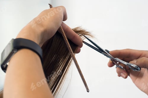 Preview: Hairdresser Cutting Woman'S Hair In Salon With Personal Perspective Of Comb And Scissors.