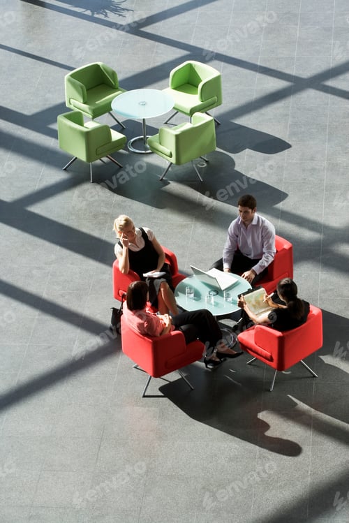Preview: Four Business Colleagues Holding A Business Meeting