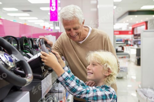 Preview: Medium Shot Of A Grandfather Watching His Grandson Play With A Video Game Steering Wheel In An