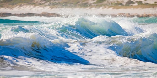 Preview: Foaming Waves Over A Rough Sea With The Coast In The Background.
