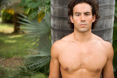 Preview: Portrait Of A Toned Muscular Man Standing In A Garden