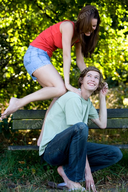 Preview: A Young Couple Having Fun On A Park Bench