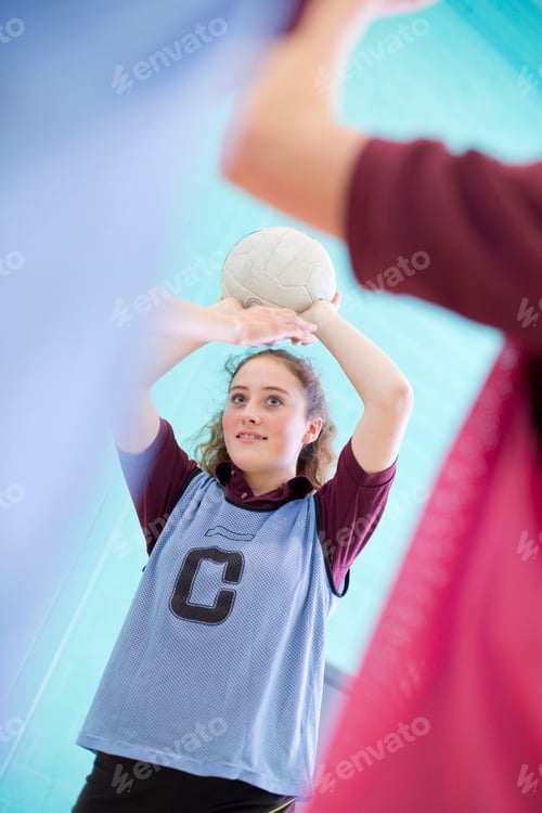 Preview: Vertical Shot Of A High School Student Playing Volleyball During A Gym Class.