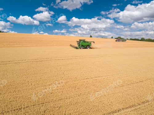 Preview: Harvest Aerial Of Combine Harvester Cutting Summer Oats Field Crop Under Blue Sky On Farm
