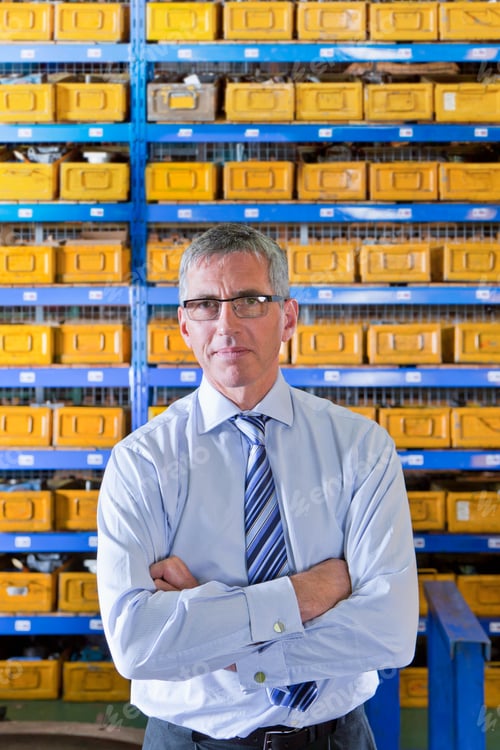 Preview: Portrait Shot Of A Businessman In Tie Looking At The Camera In A Factory.
