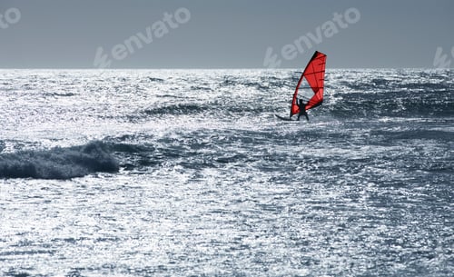 Preview: Windsurfer Windsurfing At A Distance On Sunny Windy Waves