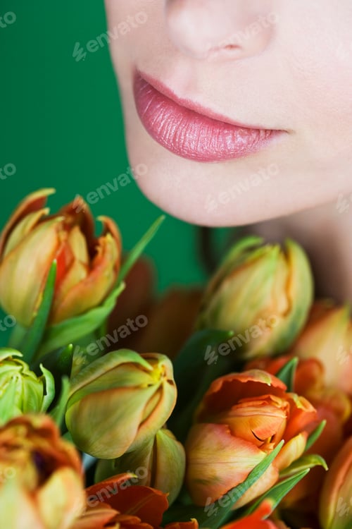Preview: A Young Woman Holding A Bunch Of Orange Tulips, Close-Up