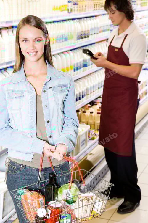 Preview: Young Woman Shopping For Groceries In Supermarket Smiling At Camera