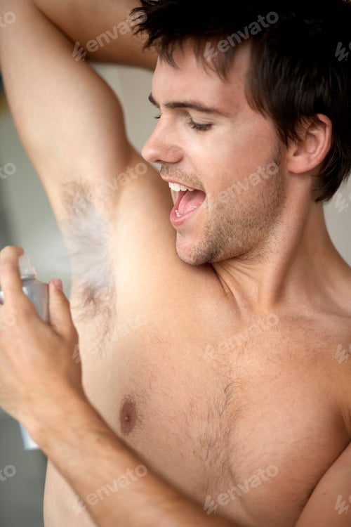 Preview: Young Man Applying De-Odorant Anti-Perspirant In The Morning