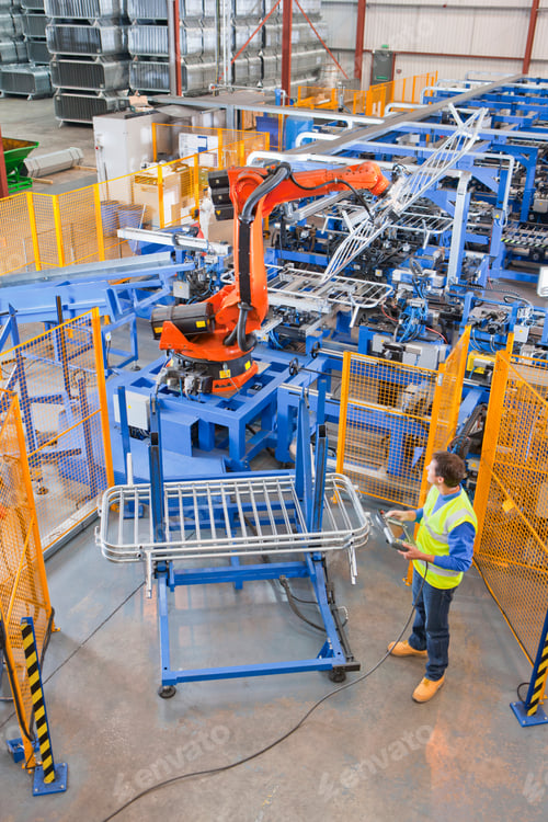 Preview: Workers Controlling Robotic Machinery Lifting Steel Fencing In Manufacturing Plant