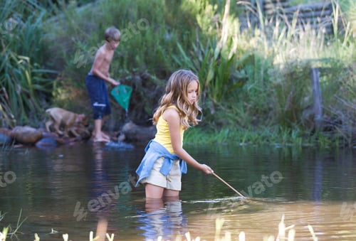 Preview: A Young Boy And Girl With Fishing Nets In A River