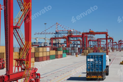 Preview: Truck Carrying A Cargo Container Along The Pathway Of A Commercial Dock.