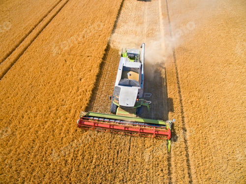 Preview: Close Aerial Shot Of A Combine Harvester In A Sunny Golden Barley Field