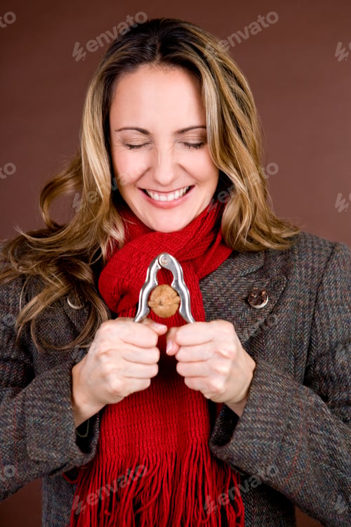 Preview: A Mid Adult Woman Cracking A Nut