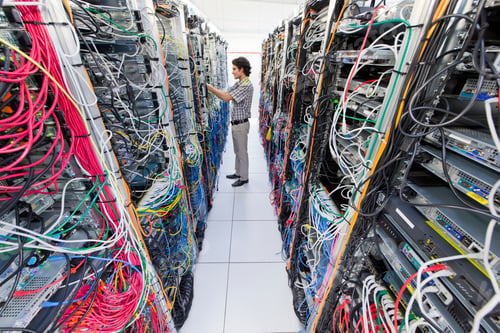 Preview: Wide Shot Of A Technician Inspecting Cables In A Server Room At A Data Center.