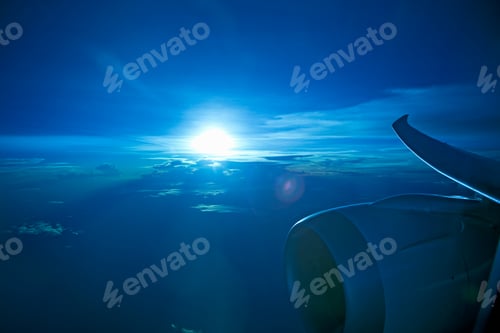 Preview: Aircraft Turbo Prop Jet Engine And Wingtip In Flight With Blue Tinted Sunset Sky And Clouds