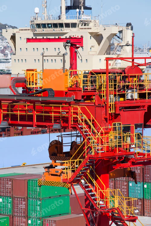 Preview: Vertical Shot Of Crane Next To A Container Ship Moored At A Commercial Dock.