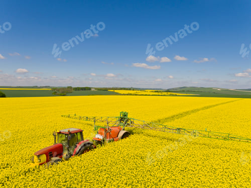 Preview: Aerial Of Tractor Spraying Oilseed Rape Crop With Pesticide