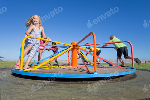 Preview: Smiling Children Riding A Carousel In A Park