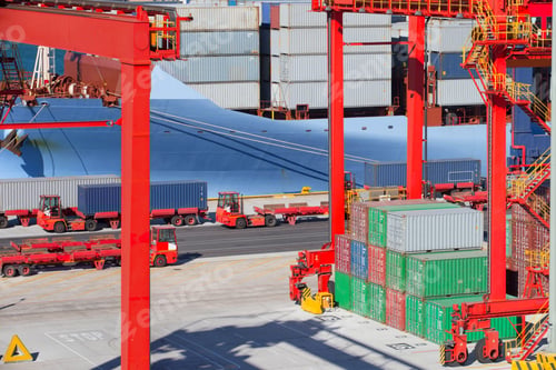 Preview: Cranes And Stacked Cargo Containers At A Commercial Dock With A Container Trucks And Ship In The