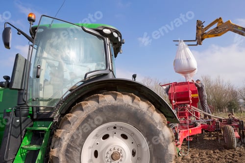 Preview: Loading Wheat Seed Into Drill Attached To Tractor In Field