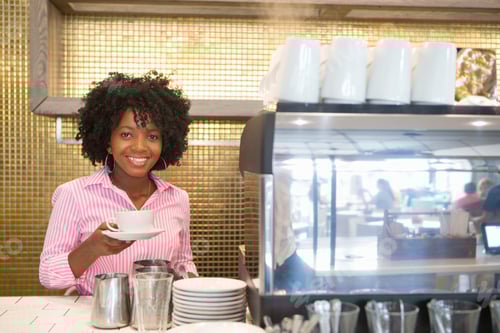 Preview: Smiling Waitress Holding A Cup Of Coffee