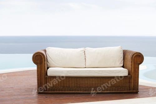 Preview: An Empty Sofa With The Sky And Water In The Background