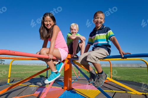 Preview: Smiling Children Sitting On A Carousel In A Park