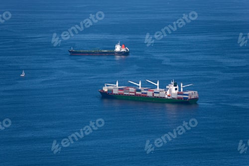 Preview: Wide Shot Of Two Cargo Ships In The Sea Only One Of Which Is Loaded With Cargo Containers