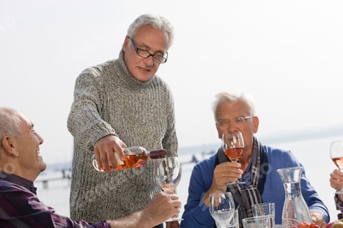 Preview: Three Senior Men Drinking Wine Beside A Lake
