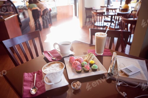 Preview: Iced Coffee, Latte, Black Coffee And Cakes On Serving Dish Beside Mp3 Player And Publications On