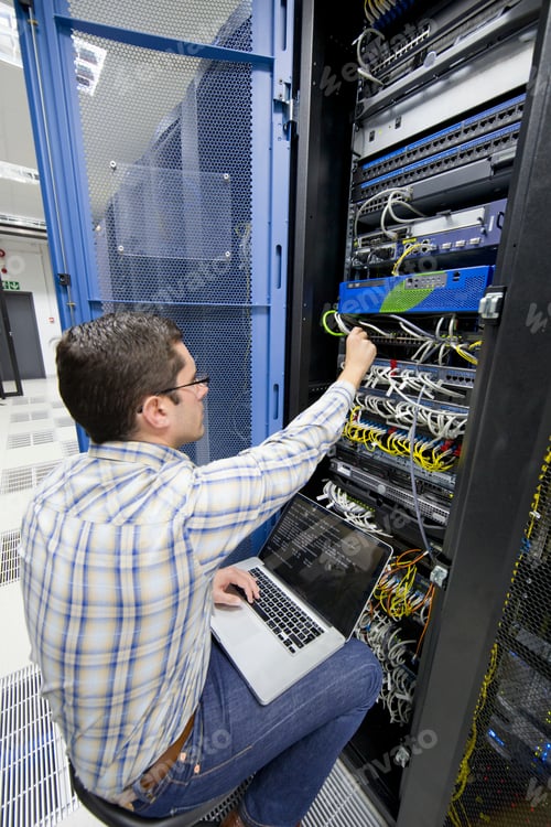 Preview: Close Up Of A Technician Sitting On A Moving Chair With A Laptop And Checking Server In The Data