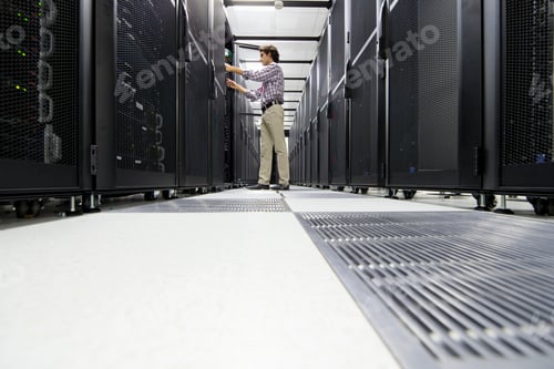 Preview: Low-Angle Shot Of A Technician Working On A Server Rack At A Data Center.
