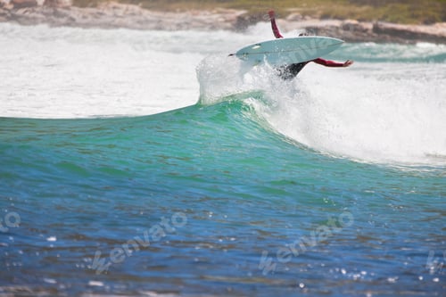 Preview: Surfer Riding Over The Crest Of A Large Wave At The Sea.